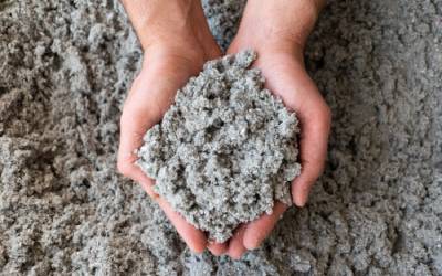 two hands holding a pile of cellulose insulation