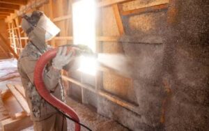 a licensed tap insulation installer blows in pest control insulation