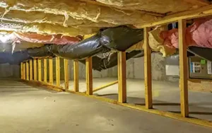 Crawl space with insulation to protect from moisture - keep your spaces moisture free with Johnson Pest Control in TN
