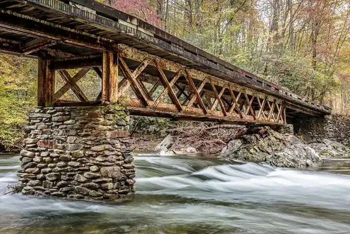 A wooden bridge above a rushing river - keep pests away from your home with Johnson Pest Control in TN