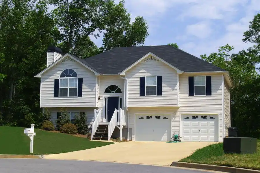 Suburban home with a lush green lawn in a suburban neighborhood - keep pests away from your home with Johnson Pest Control in TN