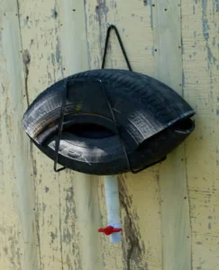 A mosquito trap made from a car tire hung on a fence - Keep mosquitoes away from your home with Johnson Pest Control in TN