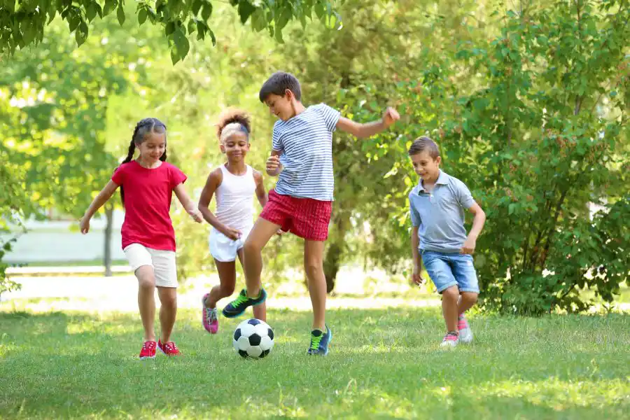 A group of kids playing soccer outside - keep mosquitoes away from your home with Johnson Pest Control in TN