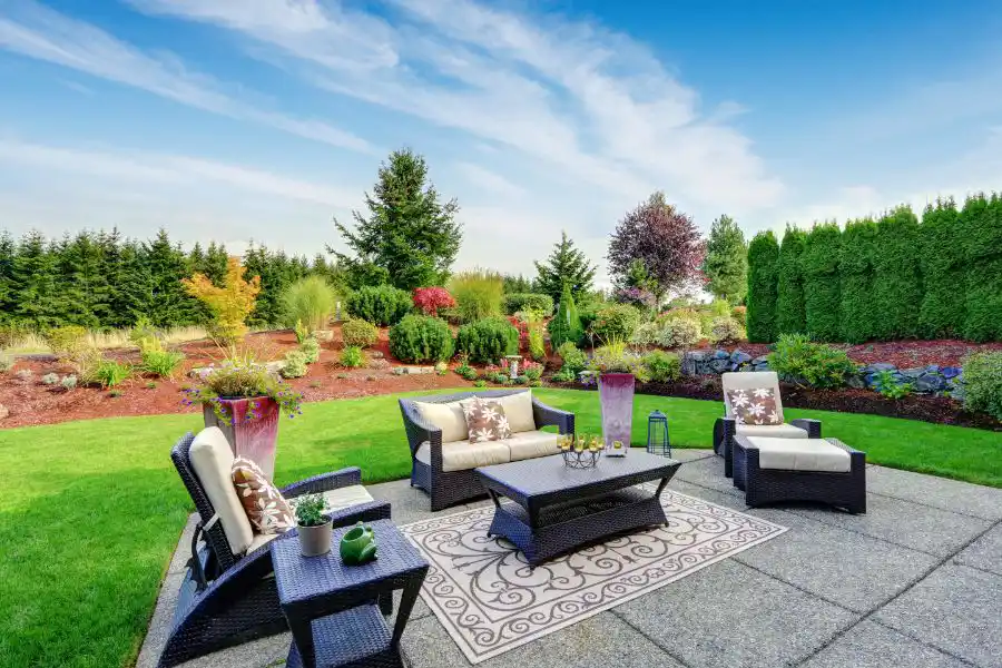 A patio with outdoor furniture and a lush green garden - keep pests away from your home with Johnson Pest Control in TN